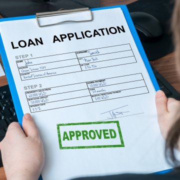woman holding loan application form credit repair